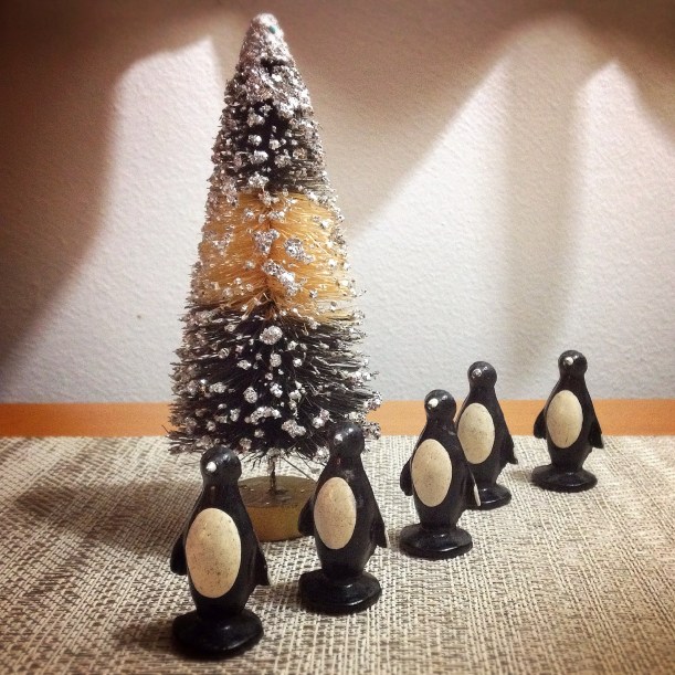The old lead penguin toys found the perfect vintage bottle brush tree.