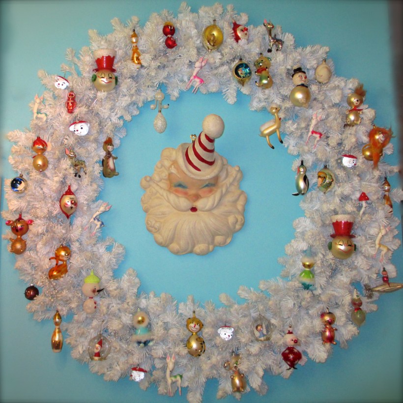 Giant white wreath with vintage Italian and West German ornaments. A very unusual, plaster, 1950's Santa Claus store display watches over the menagerie.